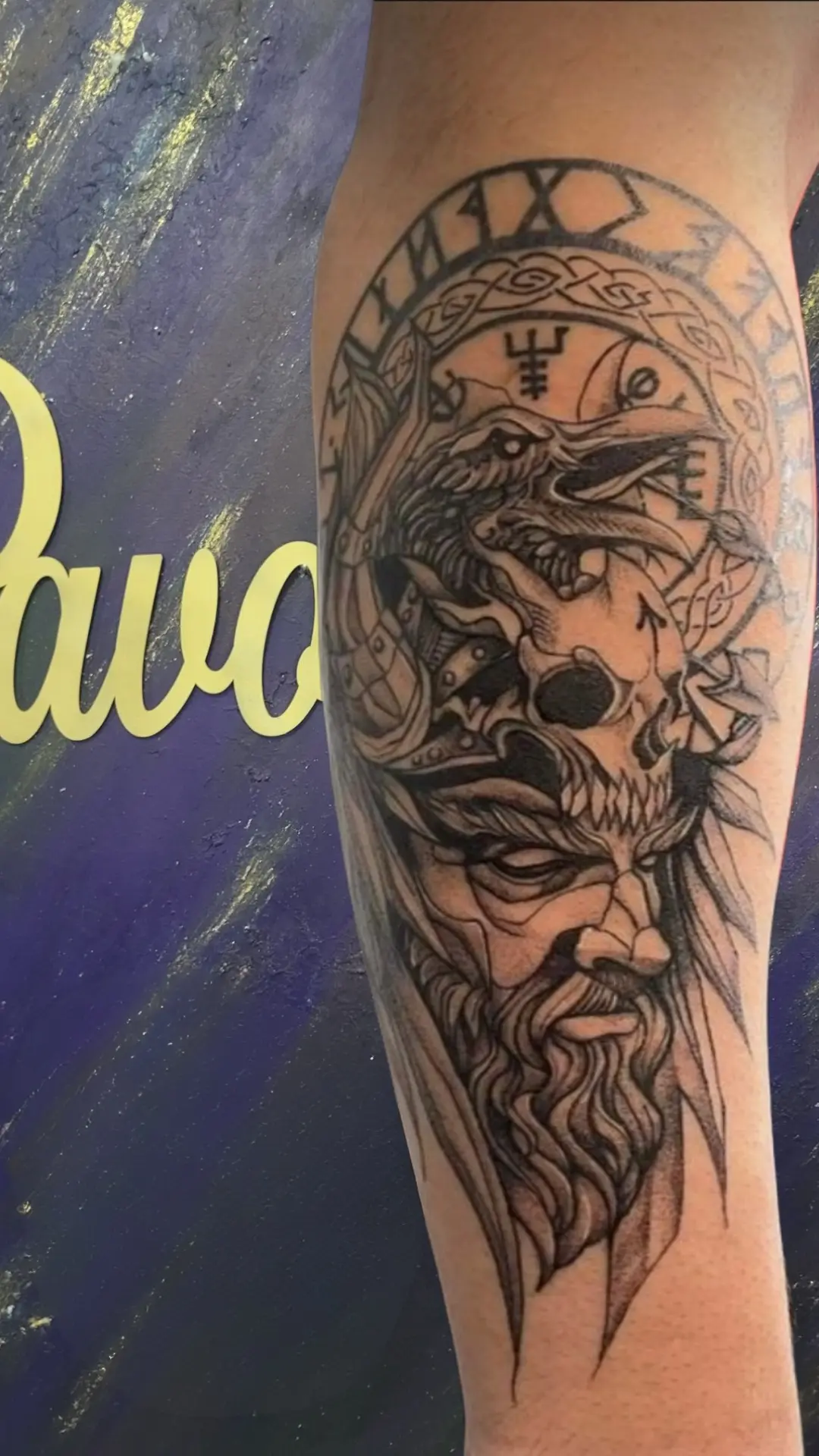 Black and grey Zeus portrait tattoo on forearm